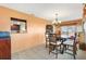 Bright dining area with wood table and chairs, view to living room and fireplace at 10195 Se 178Th Pl, Summerfield, FL 34491