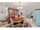 Bright dining room with wood table and chairs, showcasing a charming vintage hutch at 10195 Se 178Th Pl, Summerfield, FL 34491