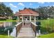 Quaint gazebo with bridge over pond, perfect for relaxing afternoons at 10195 Se 178Th Pl, Summerfield, FL 34491
