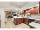 Kitchen features dark wood cabinets, granite countertops, and stainless steel appliances at 10195 Se 178Th Pl, Summerfield, FL 34491