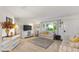 Living room with comfy sofas, large TV, and a view of the backyard at 10195 Se 178Th Pl, Summerfield, FL 34491