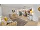 Bright living room with sofas, large TV, and view into dining area at 10195 Se 178Th Pl, Summerfield, FL 34491