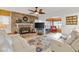 Living room features a fireplace, comfortable seating, and a large TV at 10195 Se 178Th Pl, Summerfield, FL 34491