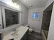 Updated bathroom with gray tile, a new vanity, and a bathtub at 11179 Sw 78Th Ct, Ocala, FL 34476