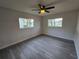 Bright bedroom featuring gray vinyl flooring and multiple windows at 11179 Sw 78Th Ct, Ocala, FL 34476