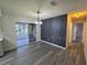 Modern dining area with gray accent wall and vinyl flooring at 11179 Sw 78Th Ct, Ocala, FL 34476