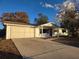 White house with covered porch, landscaped yard, and driveway at 11179 Sw 78Th Ct, Ocala, FL 34476