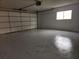 Attached garage with open garage door and painted floor at 11179 Sw 78Th Ct, Ocala, FL 34476