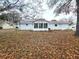 View of the back of the house showcasing its white siding and sunroom at 11179 Sw 78Th Ct, Ocala, FL 34476