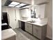 Modern kitchen featuring gray and white cabinets, new countertops, and stainless steel appliances at 11179 Sw 78Th Ct, Ocala, FL 34476