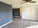 Spacious living room with gray walls and vinyl flooring at 11179 Sw 78Th Ct, Ocala, FL 34476