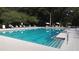 Community swimming pool with lounge chairs and umbrellas at 11179 Sw 78Th Ct, Ocala, FL 34476