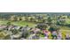 Aerial view of community, showcasing homes, lush landscaping and golf course at 13195 Se 93Rd Cir, Summerfield, FL 34491