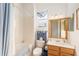 Simple bathroom with tub shower combo and wood vanity at 13195 Se 93Rd Cir, Summerfield, FL 34491
