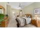 Main bedroom with a queen-size bed and ensuite bathroom access at 13195 Se 93Rd Cir, Summerfield, FL 34491