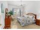Spacious bedroom with king-size bed and wood furniture at 13195 Se 93Rd Cir, Summerfield, FL 34491