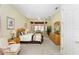 Bright bedroom with a queen bed and wood furniture at 13195 Se 93Rd Cir, Summerfield, FL 34491