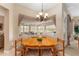 Bright dining area with a round wooden table and view of the golf course at 13195 Se 93Rd Cir, Summerfield, FL 34491