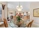 Bright dining room features a round glass-top table with four chairs at 13195 Se 93Rd Cir, Summerfield, FL 34491