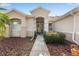 Front entrance with double doors and a stone pathway, surrounded by landscaping at 13195 Se 93Rd Cir, Summerfield, FL 34491