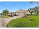 Single-story home exterior, featuring a two-car garage and well-manicured lawn at 13195 Se 93Rd Cir, Summerfield, FL 34491