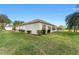 Side view of house showcasing well-maintained landscaping and a large yard at 13195 Se 93Rd Cir, Summerfield, FL 34491