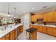 Spacious kitchen with light wood cabinets, stainless steel appliances, and an island at 13195 Se 93Rd Cir, Summerfield, FL 34491