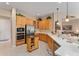 Modern kitchen with light wood cabinets and stainless steel appliances at 13195 Se 93Rd Cir, Summerfield, FL 34491