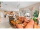 Open living room with leather sofas and view of the kitchen at 13195 Se 93Rd Cir, Summerfield, FL 34491