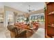 Living room features orange leather furniture and a view at 13195 Se 93Rd Cir, Summerfield, FL 34491