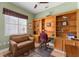 Home office with built-in shelves and comfortable seating at 13195 Se 93Rd Cir, Summerfield, FL 34491