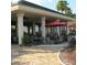 Community patio with tables, chairs, and umbrellas at 13195 Se 93Rd Cir, Summerfield, FL 34491