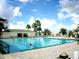 Large community pool with many people swimming at 13195 Se 93Rd Cir, Summerfield, FL 34491