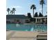 Community pool with a clubhouse and lush landscaping at 13195 Se 93Rd Cir, Summerfield, FL 34491