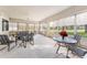 Spacious sunroom features multiple seating areas and serene golf course views at 13195 Se 93Rd Cir, Summerfield, FL 34491