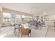 Relaxing sunroom boasts ample seating, natural light, and views of the outdoors at 13195 Se 93Rd Cir, Summerfield, FL 34491