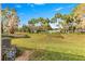 Green grassy backyard with community pool view at 1610 Ne 38Th Ter, Ocala, FL 34470