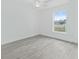 Empty bedroom featuring gray tile flooring and a large window at 16691 Sw 30Th Terrace Rd, Ocala, FL 34473