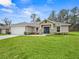 Newly constructed home with a white garage door and a nicely landscaped lawn at 16691 Sw 30Th Terrace Rd, Ocala, FL 34473
