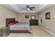 Main bedroom with a large bed, dresser, and ceiling fan at 171 Oak Circle, Ocala, FL 34472