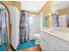 Clean bathroom with white vanity and patterned shower curtain at 2201 Nw 135Th Ln, Citra, FL 32113