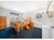 Bright bedroom featuring a wood bed frame and blue carpet at 2201 Nw 135Th Ln, Citra, FL 32113