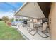 Covered patio with seating area and grill, perfect for outdoor dining at 2201 Nw 135Th Ln, Citra, FL 32113
