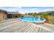 Large deck with above-ground pool, offering ample outdoor entertaining space at 2201 Nw 135Th Ln, Citra, FL 32113