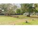 Large backyard with woodpile and mature trees at 2751 Ne 46Th St, Ocala, FL 34479