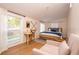Bright bedroom with wood floors, a comfortable bed, and a built-in workspace at 2751 Ne 46Th St, Ocala, FL 34479