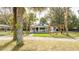Charming white cottage with a pergola, picnic table, and firepit at 2751 Ne 46Th St, Ocala, FL 34479