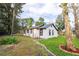 White house with black accents, a metal roof, and a well-manicured lawn at 2751 Ne 46Th St, Ocala, FL 34479