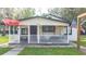 Updated farmhouse exterior, featuring a white facade and a porch at 2751 Ne 46Th St, Ocala, FL 34479