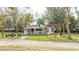 Charming white cottage with a spacious yard, pergola, and patio at 2751 Ne 46Th St, Ocala, FL 34479
